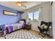 Cozy bedroom with a large window, a colorful quilt and comfortable seating at 4222 S Himalaya Way, Aurora, CO 80013