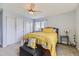 Comfortable bedroom featuring a ceiling fan, natural light, and closet at 4222 S Himalaya Way, Aurora, CO 80013