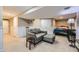 Spacious living room offering a comfortable seating area with an ottoman and neutral carpet flooring at 4222 S Himalaya Way, Aurora, CO 80013