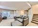 Cozy living room showcasing a neutral color scheme, a comfortable seating area, and a staircase at 4222 S Himalaya Way, Aurora, CO 80013