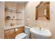 Powder room featuring decorative mirror, designer sink and shelving, and unique wall texture at 17 Canon Dr, Greenwood Village, CO 80111