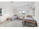 Bright bedroom with twin beds, a dresser, and a large window overlooking outside at 17 Canon Dr, Greenwood Village, CO 80111