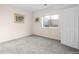 Carpeted bedroom features a window and door to the outside at 17 Canon Dr, Greenwood Village, CO 80111