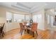 Bright dining area with hardwood floors, a modern glass table and large windows for natural light at 17 Canon Dr, Greenwood Village, CO 80111