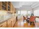 Eat-in kitchen dining nook featuring a round glass table, upholstered chairs and bright windows at 17 Canon Dr, Greenwood Village, CO 80111