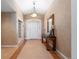 Inviting entryway features tiled floors, neutral paint, and an elegant console table with decorative mirror and lighting at 17 Canon Dr, Greenwood Village, CO 80111