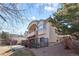 Elegant home exterior featuring a private balcony, stone accents, and manicured landscaping at 17 Canon Dr, Greenwood Village, CO 80111