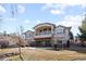 Elegant home exterior featuring a private balcony, stone accents, and manicured landscaping at 17 Canon Dr, Greenwood Village, CO 80111