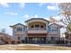 Elegant home exterior featuring a private balcony, stone accents, and manicured landscaping at 17 Canon Dr, Greenwood Village, CO 80111