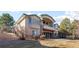 Elegant home exterior featuring a private balcony, stone accents, and manicured landscaping at 17 Canon Dr, Greenwood Village, CO 80111