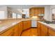 Well-lit kitchen with ample counter space, stainless steel appliances, and natural wood cabinetry at 17 Canon Dr, Greenwood Village, CO 80111