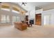 Spacious living room featuring a cozy fireplace, built-in bookshelves, and lots of natural light at 17 Canon Dr, Greenwood Village, CO 80111