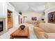 Spacious living room featuring a cozy fireplace, built-in bookshelves, and view to the dining room at 17 Canon Dr, Greenwood Village, CO 80111