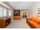 Cozy living room boasts natural light, built-in shelving, and an inviting leather couch at 17 Canon Dr, Greenwood Village, CO 80111