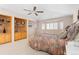 Bright, carpeted main bedroom with a ceiling fan and built-in shelving for decorative display and storage at 17 Canon Dr, Greenwood Village, CO 80111