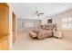 Spacious bedroom featuring plush carpet, built-in shelves, and an abundance of natural light from many windows at 17 Canon Dr, Greenwood Village, CO 80111