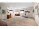 Large carpeted recreation room with an exercise bike and a built-in bookshelf at 17 Canon Dr, Greenwood Village, CO 80111