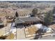 Aerial view of a single Gathering home with a well maintained front yard in winter and a backdrop of frosted trees at 4192 S Vrain St, Denver, CO 80236