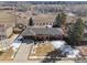 Aerial view of a brick home with a spacious yard, mature trees, and a long driveway at 4192 S Vrain St, Denver, CO 80236