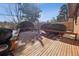 Wooden backyard deck featuring built-in bench seating and a charming view of surrounding foliage and fenced yard at 4192 S Vrain St, Denver, CO 80236