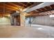 Unfinished basement with exposed beams, concrete walls and floors and stairs at 4192 S Vrain St, Denver, CO 80236