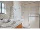 A clean bathroom with a sink, a toilet, and a shower with sliding doors at 4192 S Vrain St, Denver, CO 80236