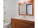 Bathroom featuring a single sink vanity, mirror, and a tub with white tile at 4192 S Vrain St, Denver, CO 80236