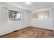 Bright, simple bedroom with a neutral color palette and large window views at 4192 S Vrain St, Denver, CO 80236