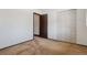 A bright bedroom featuring carpet and closet with doors at 4192 S Vrain St, Denver, CO 80236