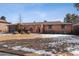 Charming single-story brick home with arched entryway, manicured bushes, and attached two-car garage at 4192 S Vrain St, Denver, CO 80236