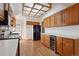 Well-lit kitchen featuring wood cabinets, modern appliances, and hardwood flooring at 4192 S Vrain St, Denver, CO 80236