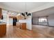 Open kitchen showcasing wood cabinetry, a modern chandelier, and seamless connectivity to the living room at 4192 S Vrain St, Denver, CO 80236