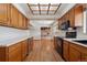 Well-lit kitchen with wood cabinets, modern appliances, and a seamless transition to the Gathering room at 4192 S Vrain St, Denver, CO 80236