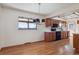 Bright and airy kitchen featuring modern appliances and ample countertop space with hardwood flooring at 4192 S Vrain St, Denver, CO 80236