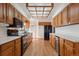 Classic kitchen featuring warm wood cabinets, black appliances, and ample counter space, perfect for cooking at 4192 S Vrain St, Denver, CO 80236