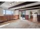 Spacious living room with exposed beams, wood paneling, and sliding doors to the backyard at 4192 S Vrain St, Denver, CO 80236