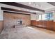 Cozy living room with a brick fireplace, exposed beams, and wood paneling at 4192 S Vrain St, Denver, CO 80236