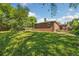 Lush green backyard with a well-maintained lawn and mature trees at 7350 W 21St Ave, Lakewood, CO 80214