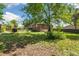 Spacious backyard featuring a lawn and mature trees surrounding the home at 7350 W 21St Ave, Lakewood, CO 80214