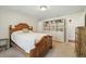 Cozy bedroom featuring a wooden bed frame and built-in shelving for storage at 7350 W 21St Ave, Lakewood, CO 80214