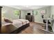 Comfortable bedroom with wood floors, two windows for ample light, and desk area at 7350 W 21St Ave, Lakewood, CO 80214