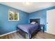 Inviting bedroom with wood flooring, large window, side table, and cozy decor at 7350 W 21St Ave, Lakewood, CO 80214