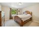 Neutral bedroom with a large window, hardwood bed frame, and natural light at 7350 W 21St Ave, Lakewood, CO 80214