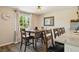 Dining area featuring a wooden table, chairs, a window, and stylish decor at 7350 W 21St Ave, Lakewood, CO 80214