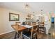 Cozy dining area with a wooden table, bar-height seating, and modern lighting fixtures at 7350 W 21St Ave, Lakewood, CO 80214