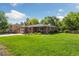 A beautiful brick house with an expansive lawn, mature trees, and an attached garage at 7350 W 21St Ave, Lakewood, CO 80214