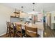 A kitchen with bar-height seating, granite counters, stylish backsplash, and modern lighting at 7350 W 21St Ave, Lakewood, CO 80214