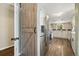 Modern kitchen with stainless steel appliances and adjacent wooden barn door at 7350 W 21St Ave, Lakewood, CO 80214