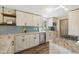 Bright kitchen featuring stainless steel appliances, granite countertops, and light wood cabinets at 7350 W 21St Ave, Lakewood, CO 80214