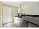Well-lit laundry room with newer washer and dryer units and door to the outside at 7350 W 21St Ave, Lakewood, CO 80214